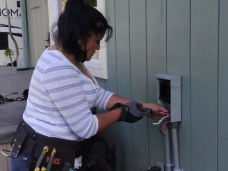 Licensed electrician wiring an exterior subpanel in Whiteland